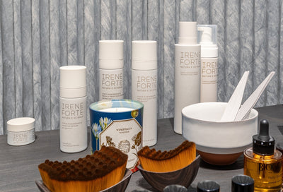 Irene Forte skincare products and tools arranged on a table, available at Sommetbeauty.