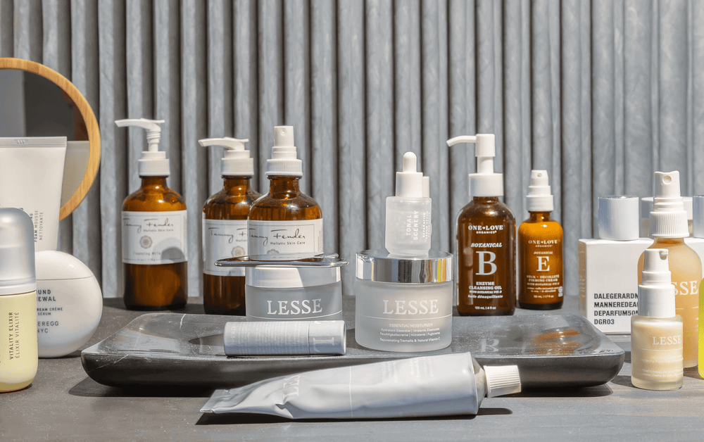 Assorted skincare products from LESSE, Tammy Fender, and One Love Organics arranged on a spa counter display.