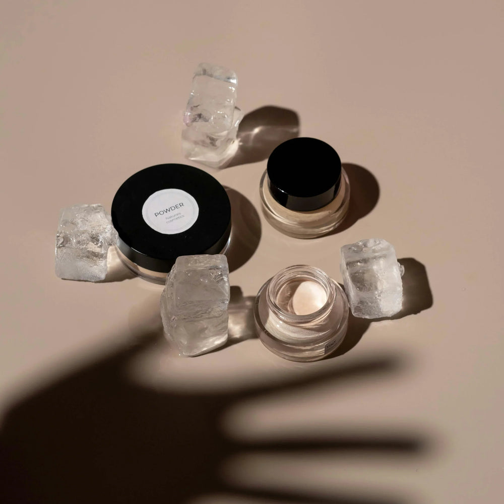 Sommetbeauty skincare powders and creams styled with ice cubes on a beige background.