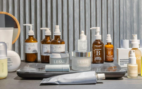 Collection of Lesse and other natural skincare products including moisturizers, serums, and enzyme cleansing oils on tray.