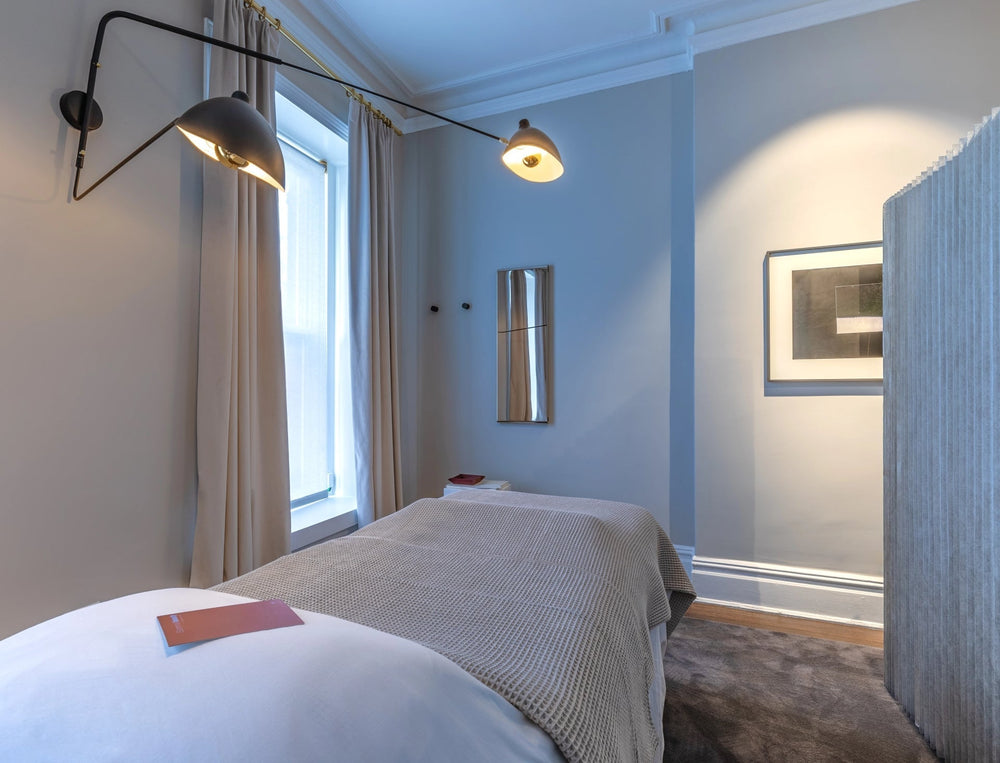 Sommetbeauty spa room with a bed and lights, created for collagen boost facial. 
